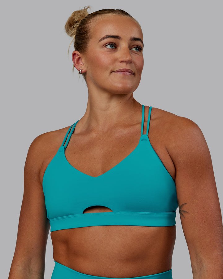 Woman wearing Pursue Sports Bra - Blue Bird
