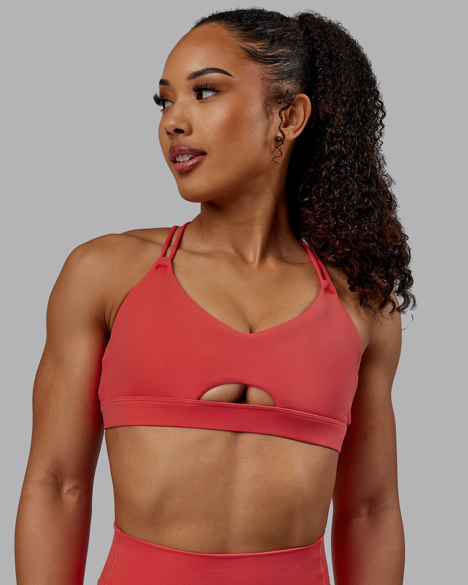 Woman wearing Pursue Sports Bra - Cayenne