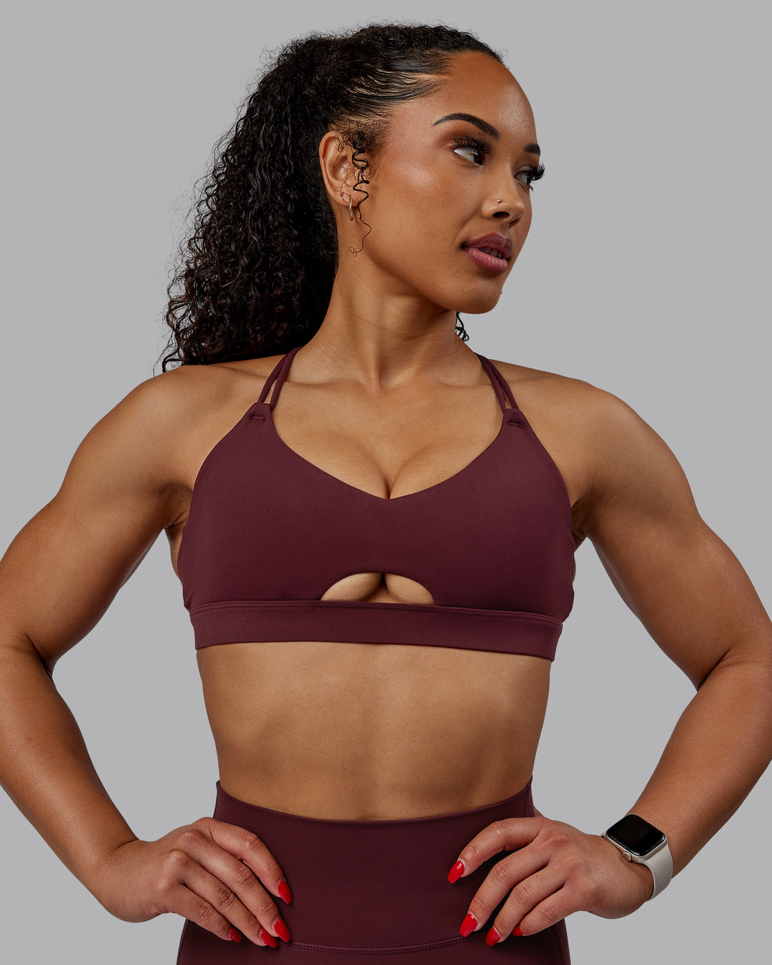 Woman wearing Pursue Sports Bra - Dark Cherry