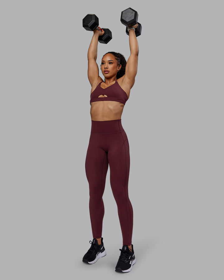 Woman wearing Pursue Sports Bra - Dark Cherry
