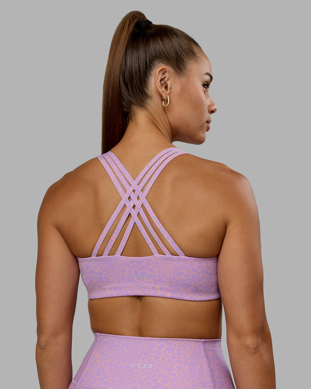 Woman wearing Push The Limit Sports Bra - Pale Lilac Vitality Print