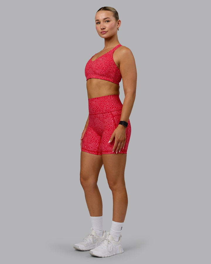 Woman wearing Push The Limit Sports Bra - Red Vitality Print
