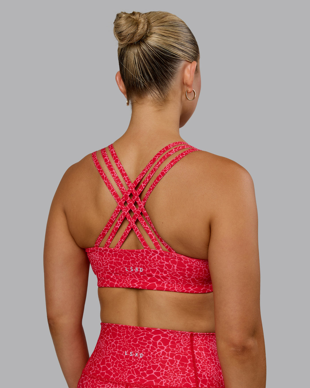 Woman wearing Push The Limit Sports Bra - Red Vitality Print