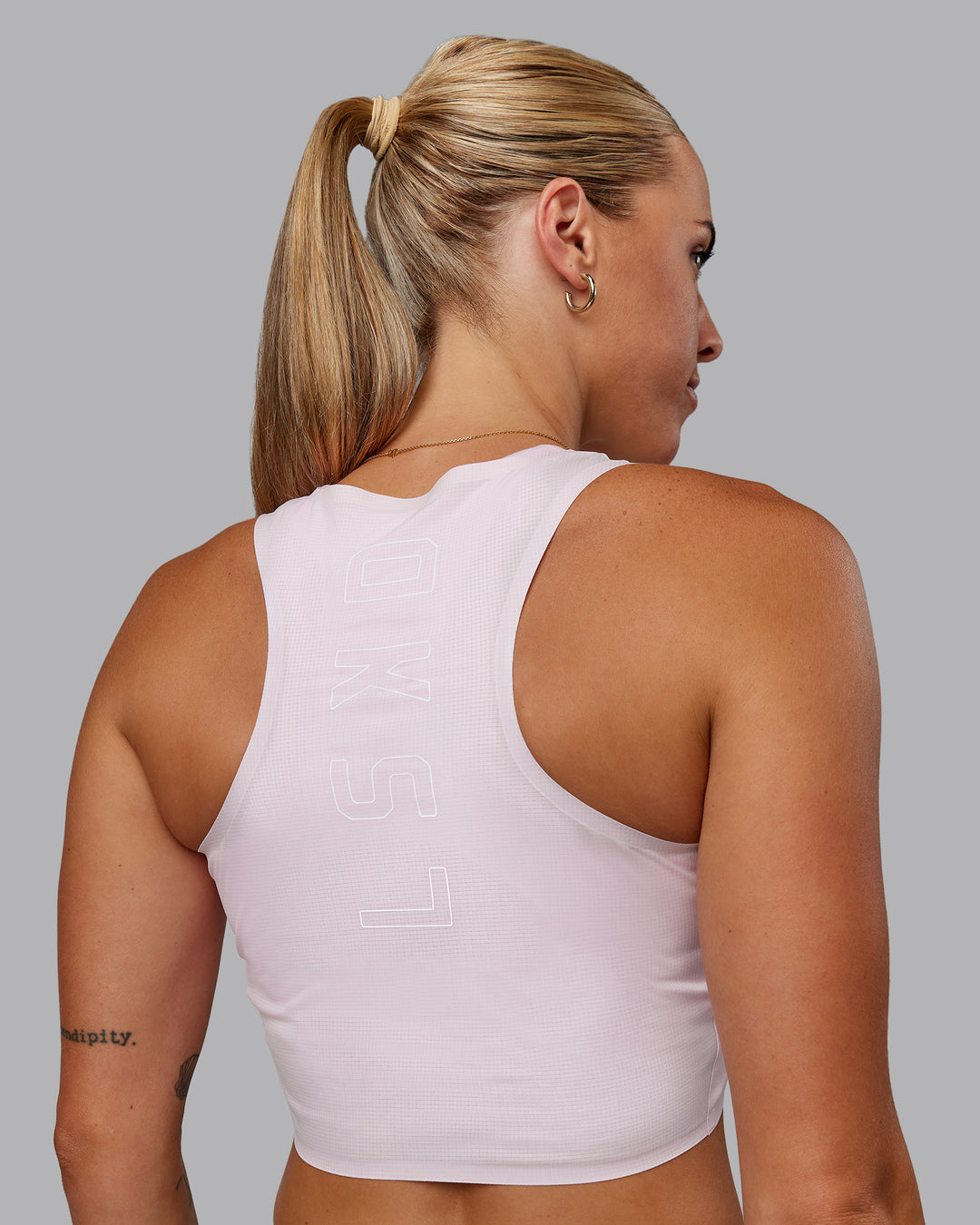 Woman wearing Race Day Cropped Performance Tank - Festival Bloom-White