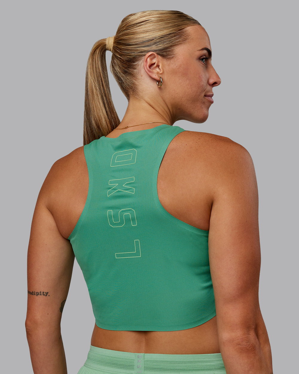 Woman wearing Race Day Cropped Performance Tank - Mystic Green-Surreal Green