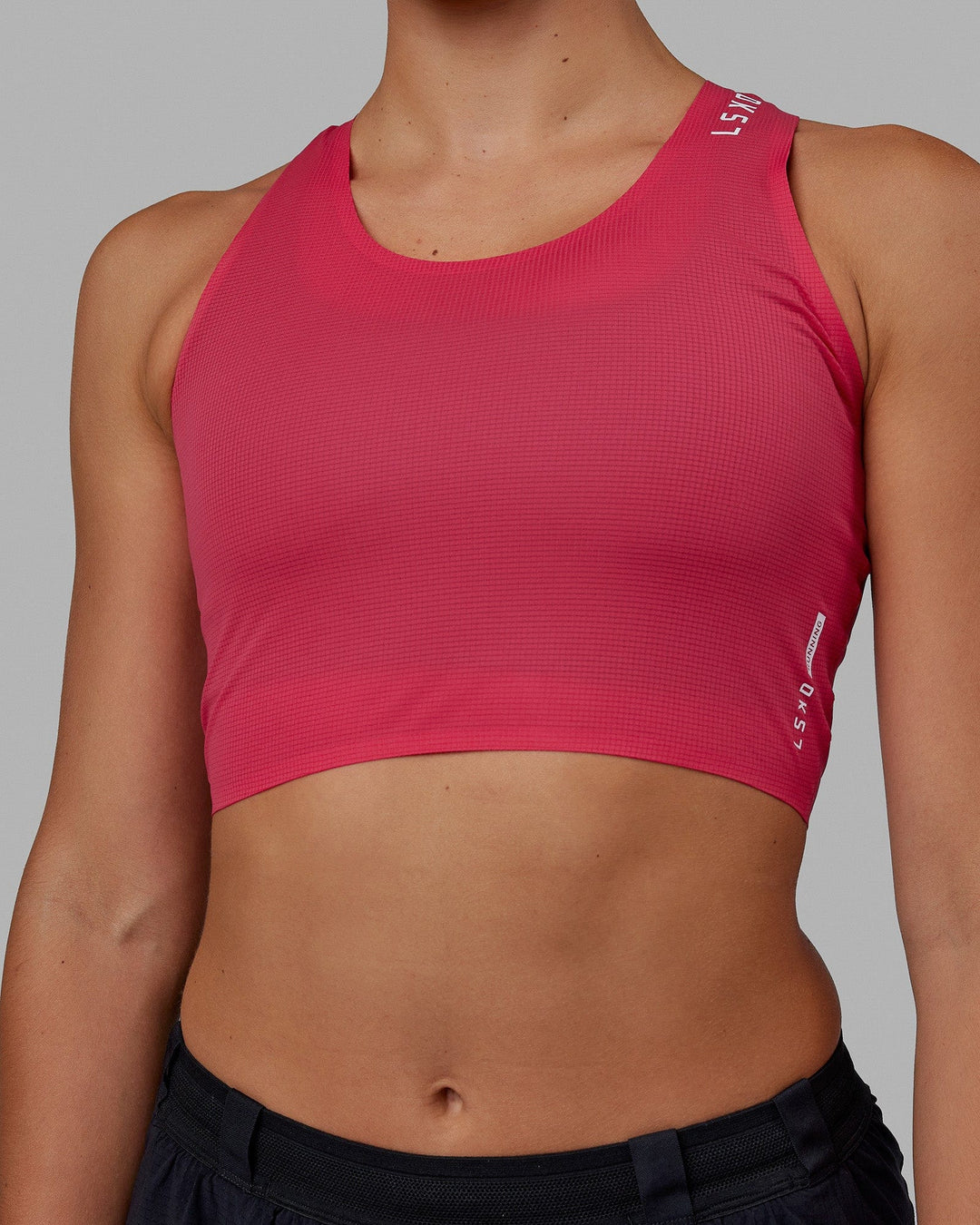 Woman wearing Race Day Cropped Performance Tank - Raspberry-White