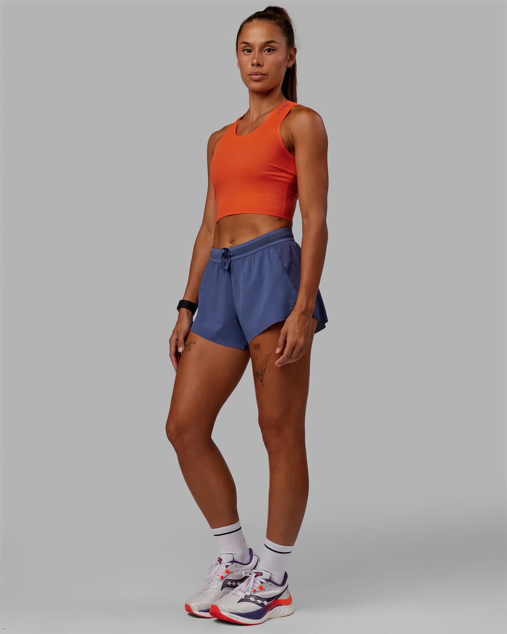 Woman wearing Race Day Cropped Performance Tank - Ultra Orange-Future Dusk