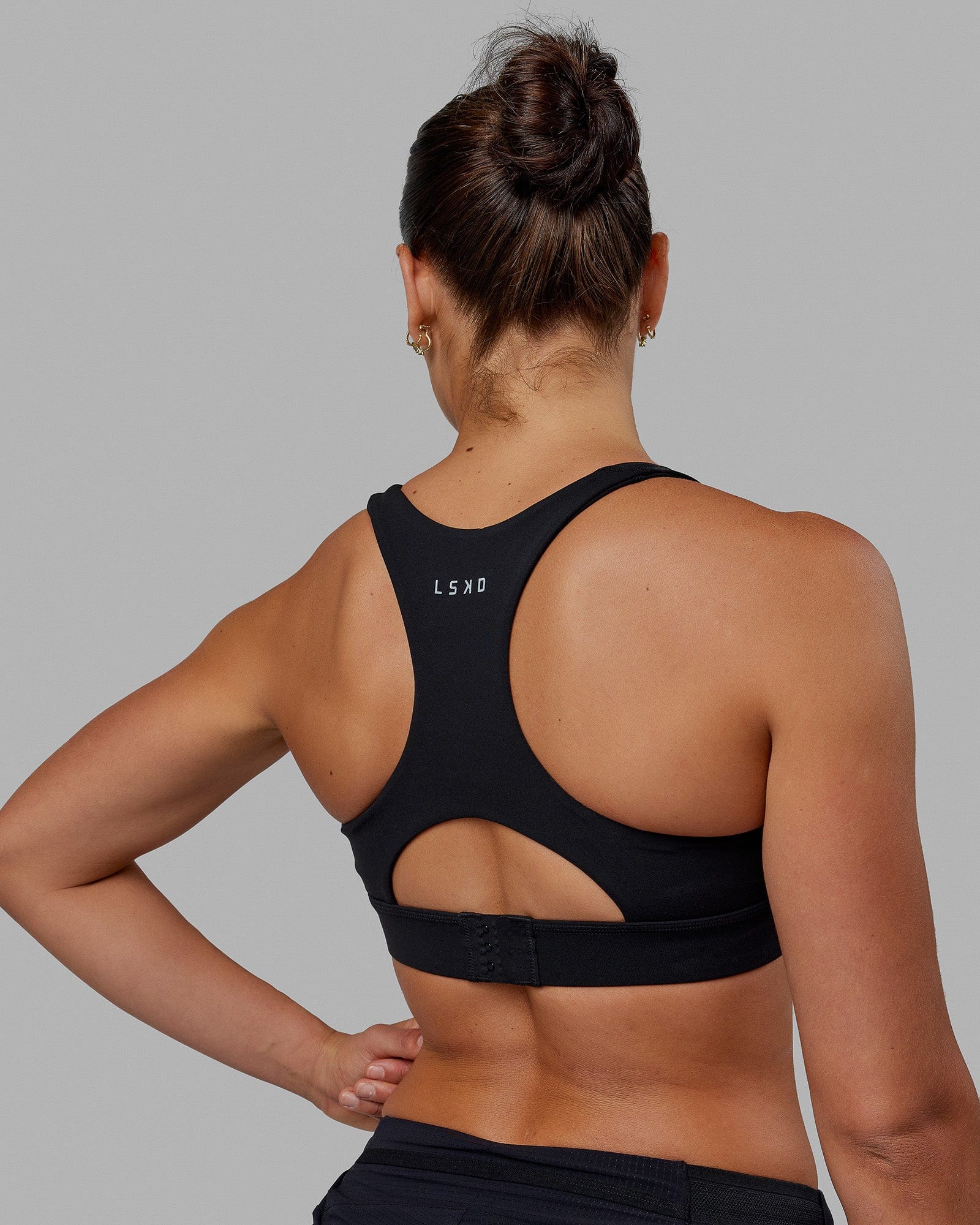 Woman wearing Race Day Sports Bra - Black