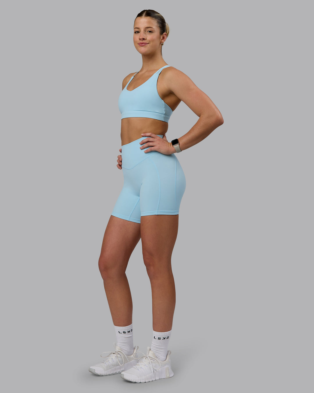 Woman wearing Radiance Sports Bra - Crystal Blue