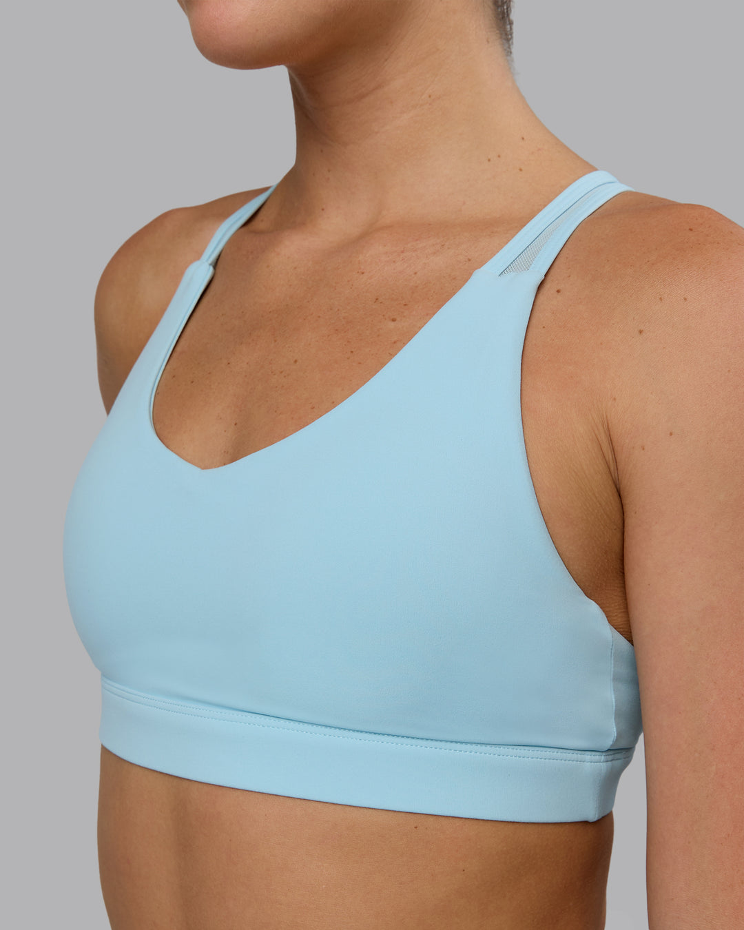 Woman wearing Radiance Sports Bra - Crystal Blue