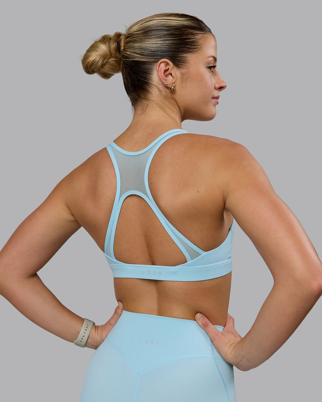 Woman wearing Radiance Sports Bra - Crystal Blue