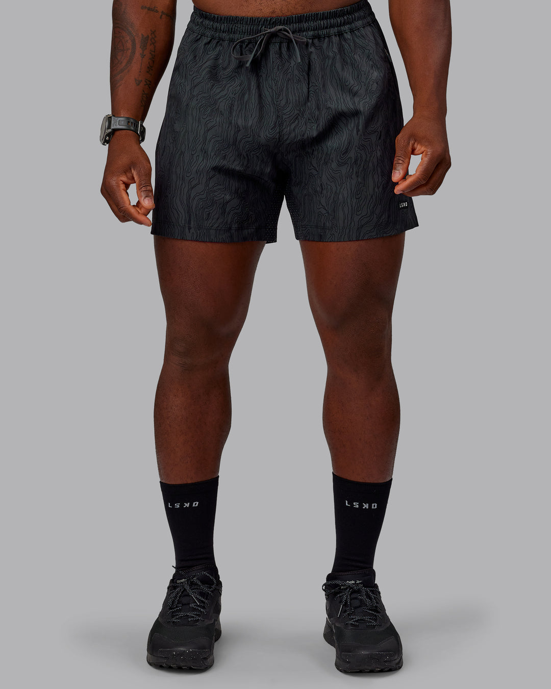 Man wearing Rep 5&quot; Performance Shorts - Topographic Black 