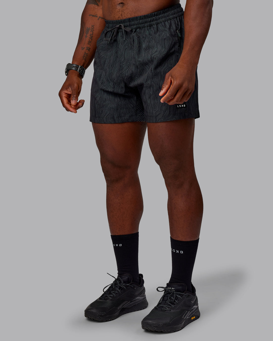 Man wearing Rep 5&quot; Performance Shorts - Topographic Black 