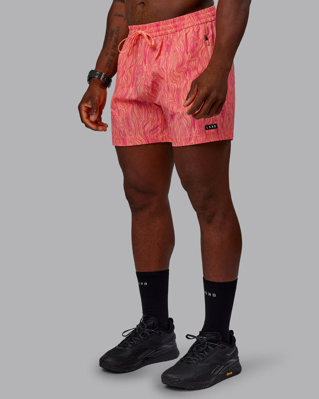 Man wearing Rep 5&quot; Performance Shorts - Topographic Peach