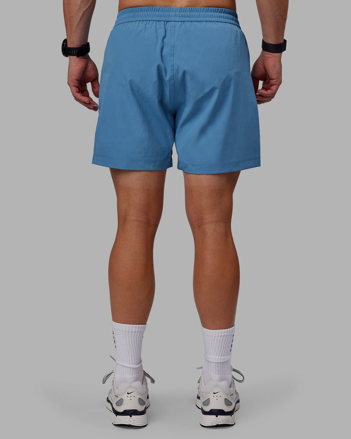 Man wearing Rep 5&quot; Performance Shorts - Elemental Blue
