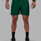 Man wearing Rep 7" Performance Shorts - Deep Emerald