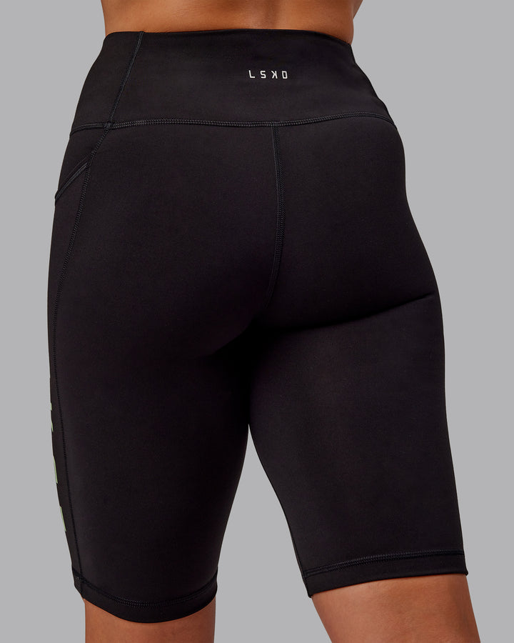 Woman wearing Rep Bike Shorts - Black-Surreal Green
