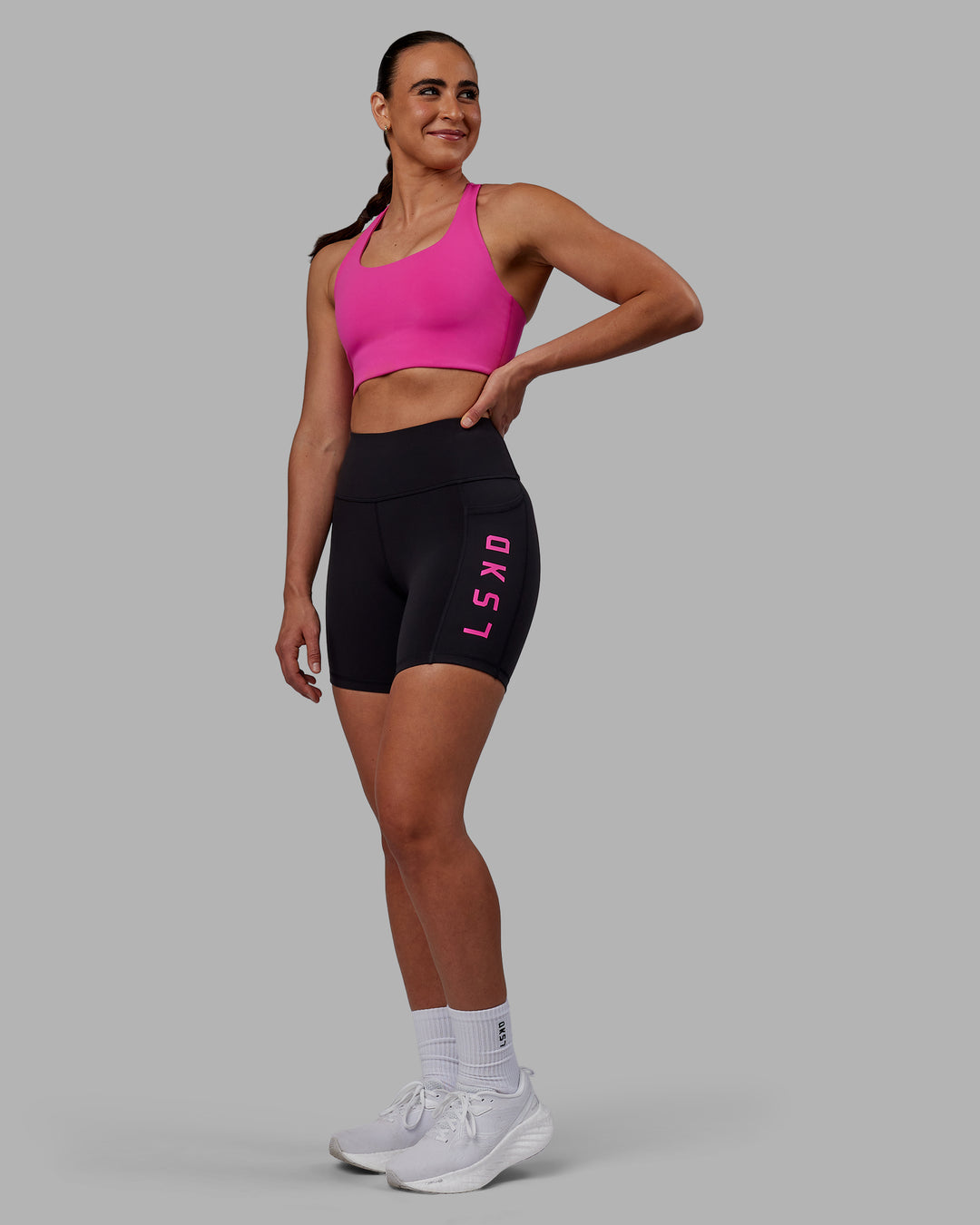 Woman wearing Rep Mid Short Tights - Black-Fuchsia Pink