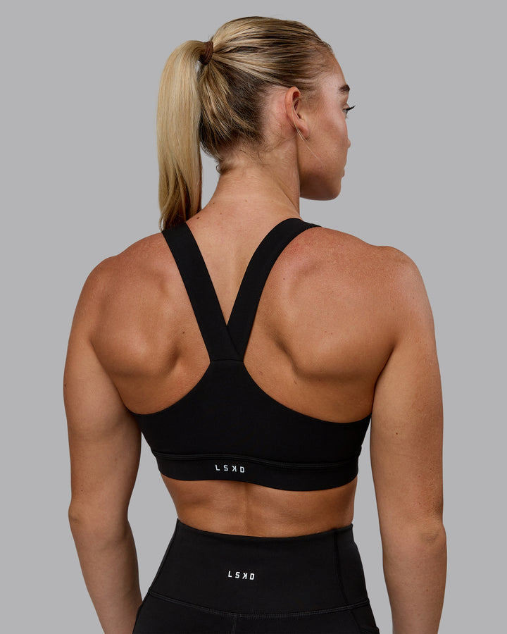 Woman wearing Rep Sports Bra - Black-Bubblegum
