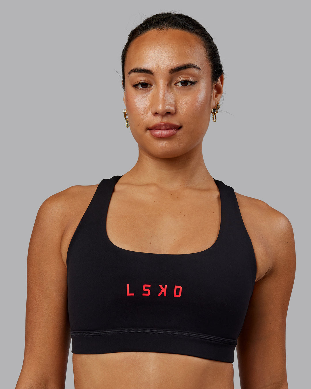 Woman wearing Rep Sports Bra - Black-Scarlet