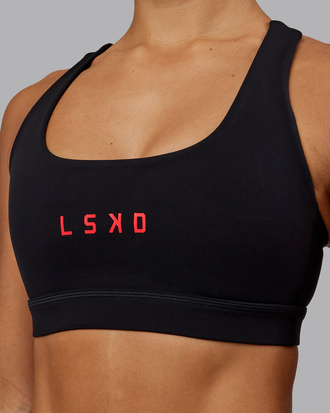 Woman wearing Rep Sports Bra - Black-Scarlet