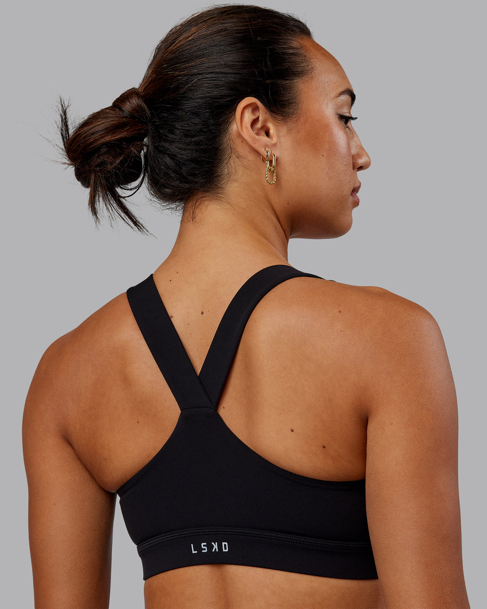 Woman wearing Rep Sports Bra - Black-Scarlet