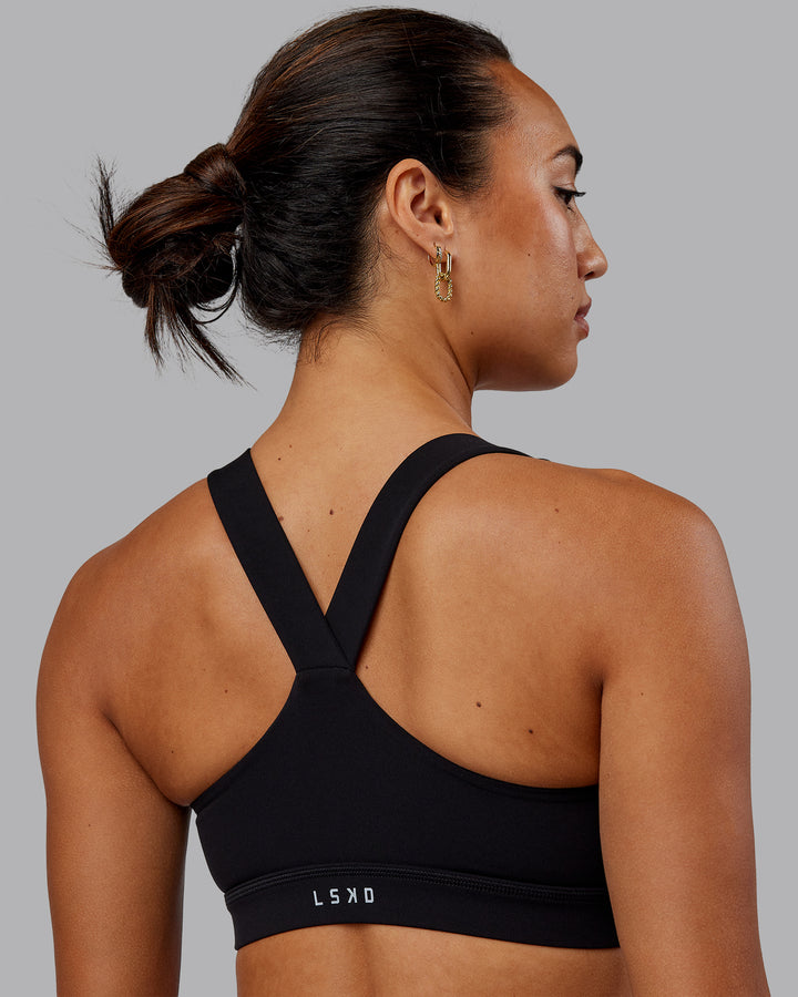 Woman wearing Rep Sports Bra - Black-Scarlet
