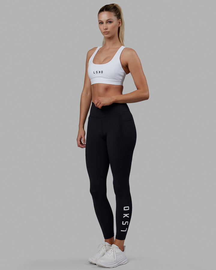 Woman wearing Rep Sports Bra Small Logo - White-Black
