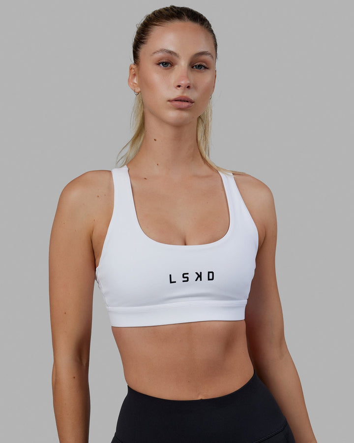 Woman wearing Rep Sports Bra Small Logo - White-Black
