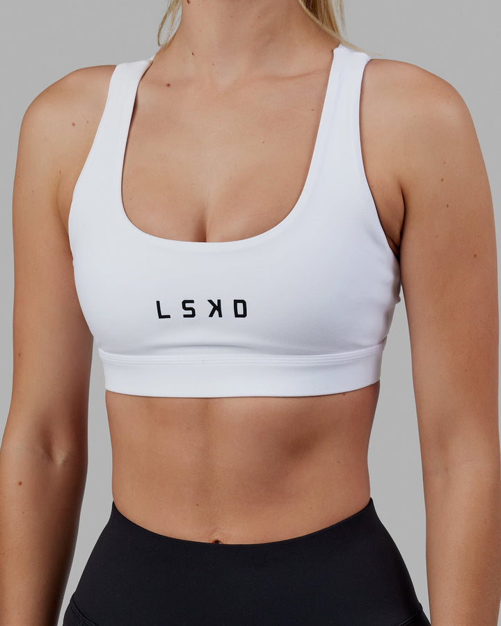 Woman wearing Rep Sports Bra Small Logo - White-Black
