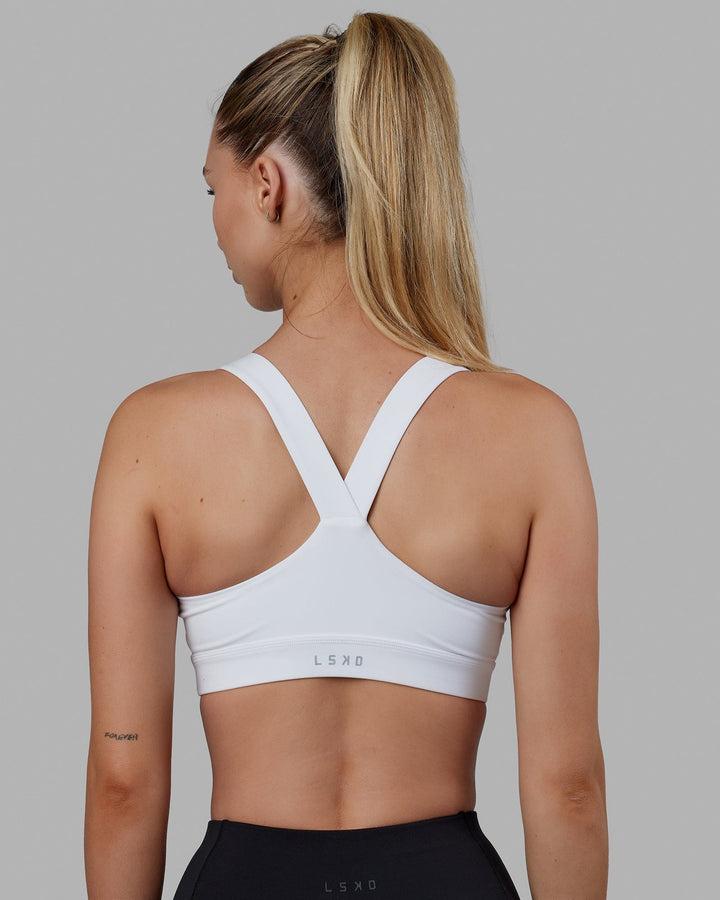 Woman wearing Rep Sports Bra Small Logo - White-Black
