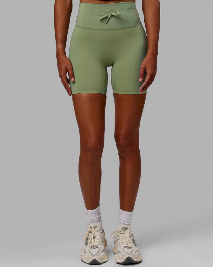 Woman wearing Resistance Mid Short Tights - Bayleaf
