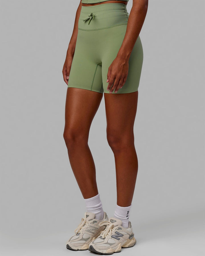 Woman wearing Resistance Mid Short Tights - Bayleaf
