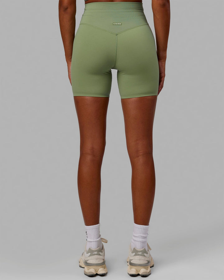 Woman wearing Resistance Mid Short Tights - Bayleaf
