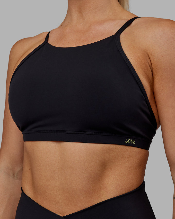 Woman wearing Sara Ares High Neck Sports Bra - Black
