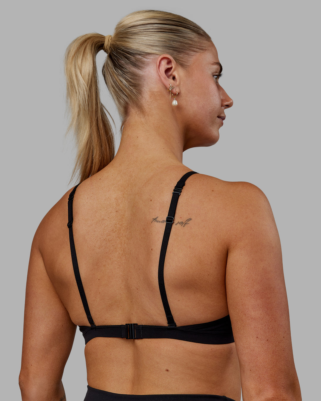 Woman wearing Sara Ares High Neck Sports Bra - Black