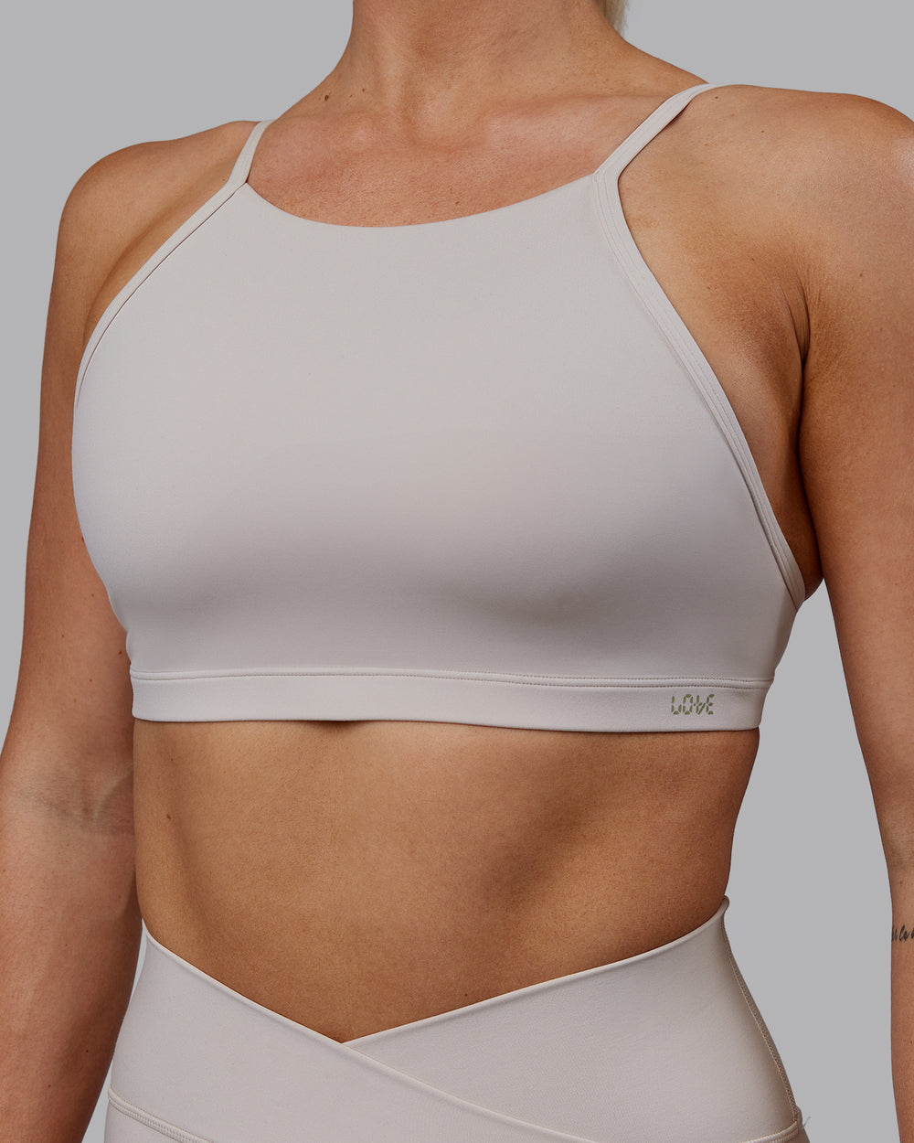 Woman wearing Sara Ares High Neck Sports Bra - Shale Beige