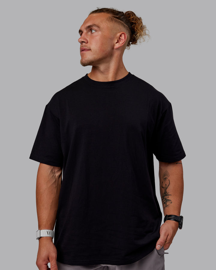 Man wearing Sara GET ÆTLA SKAL Unisex FLXCotton Tee Oversize - Black-White
