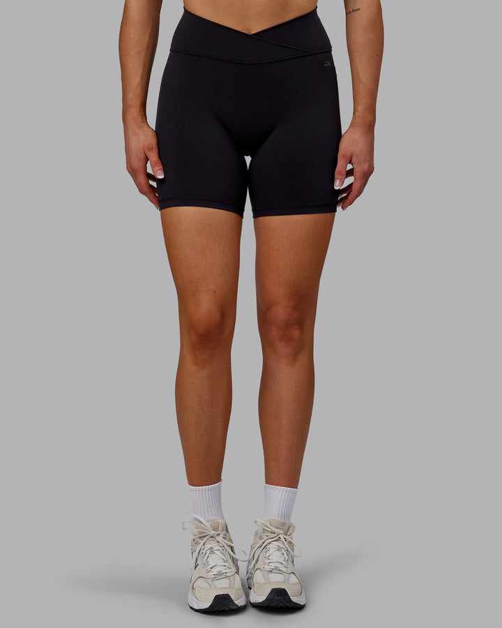 Woman wearing Sara Strike Cross Over Waist Mid Short Tights - Black
