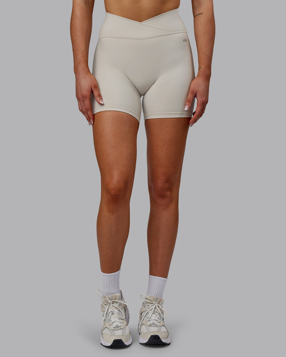 Woman wearing Sara Strike Cross Over Waist Mid Short Tights - Shale Beige