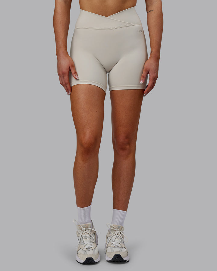 Woman wearing Sara Strike Cross Over Waist Mid Short Tights - Shale Beige
