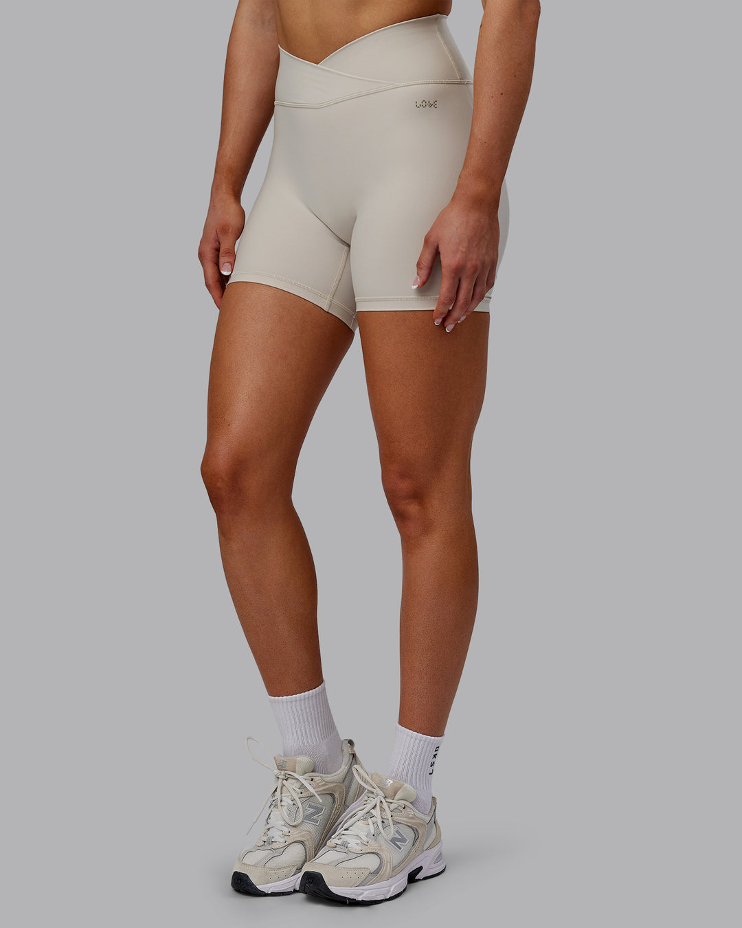 Woman wearing Sara Strike Cross Over Waist Mid Short Tights - Shale Beige