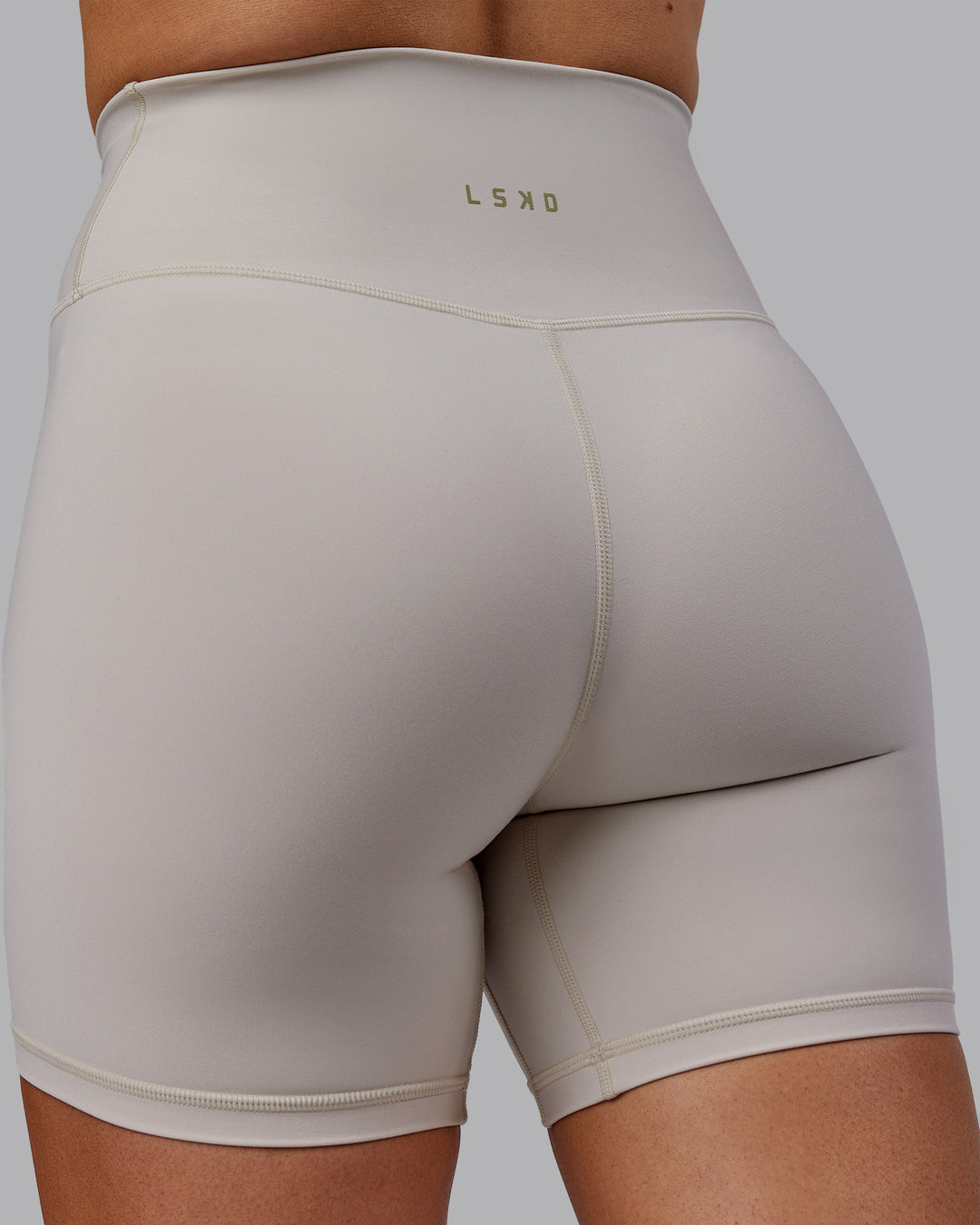 Woman wearing Sara Strike Cross Over Waist Mid Short Tights - Shale Beige