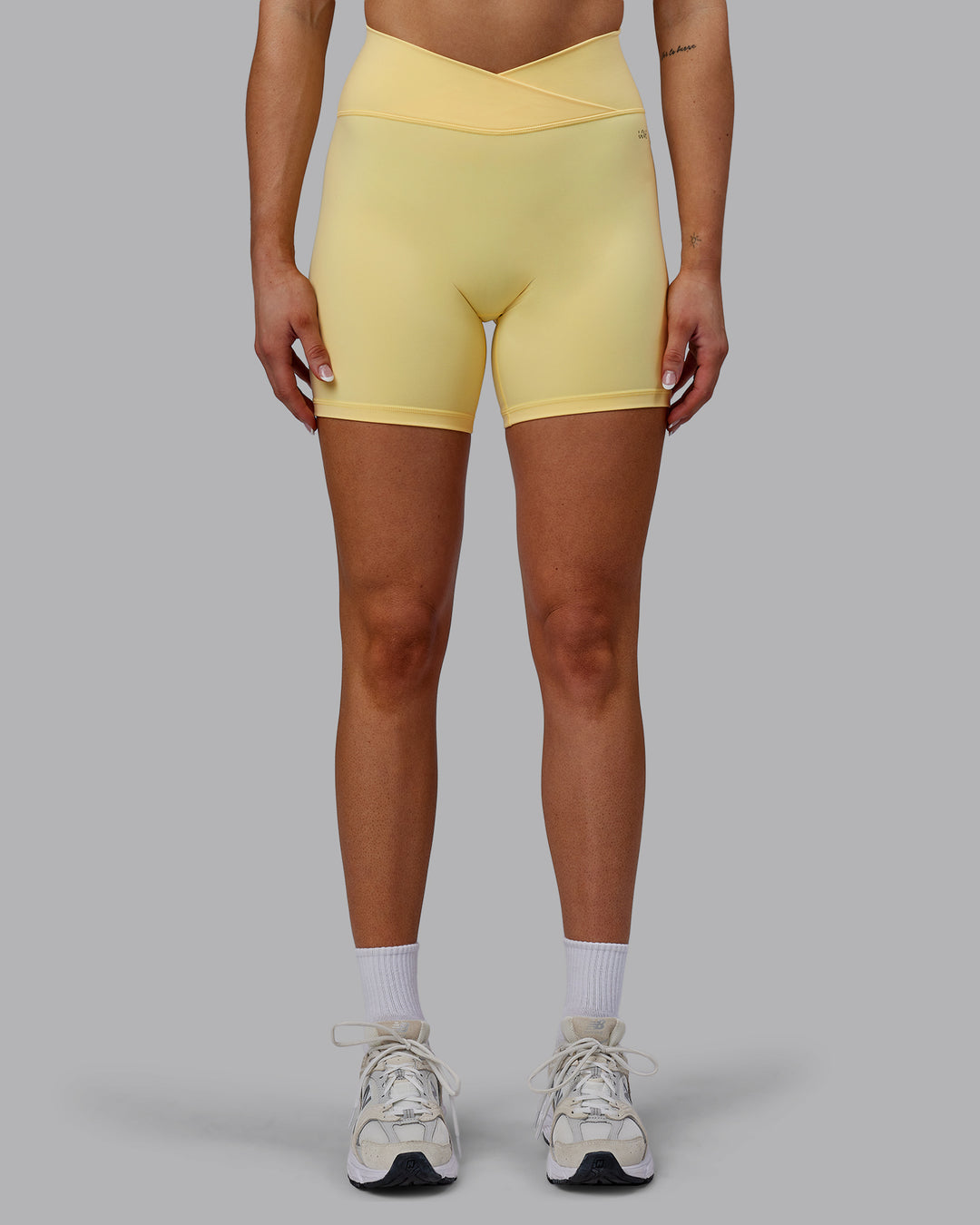 Woman wearing Sara Strike Cross Over Waist Mid Short Tights - Sunflower