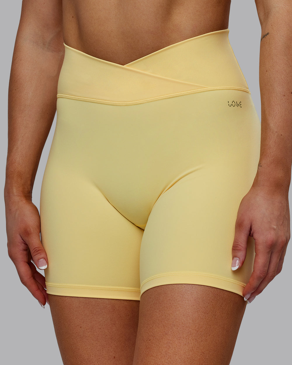 Woman wearing Sara Strike Cross Over Waist Mid Short Tights - Sunflower