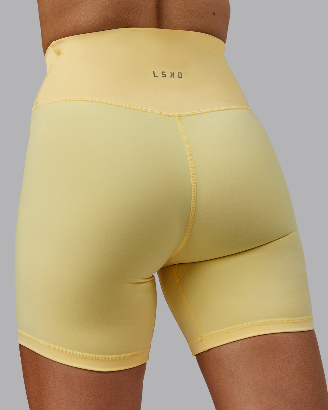 Woman wearing Sara Strike Cross Over Waist Mid Short Tights - Sunflower