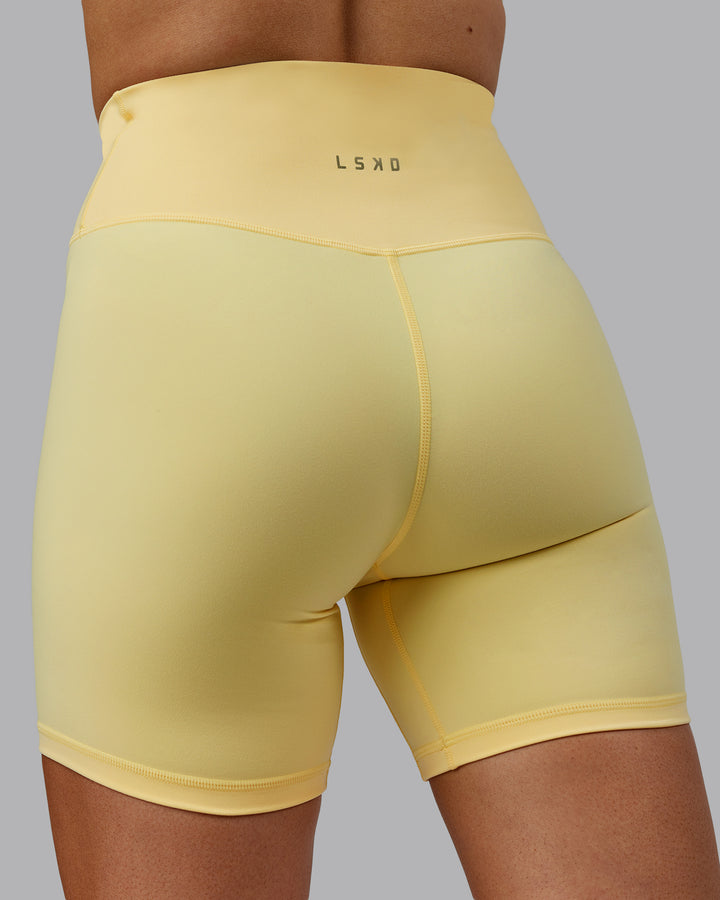 Woman wearing Sara Strike Cross Over Waist Mid Short Tights - Sunflower
