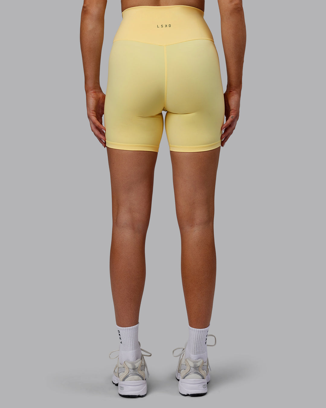 Woman wearing Sara Strike Cross Over Waist Mid Short Tights - Sunflower