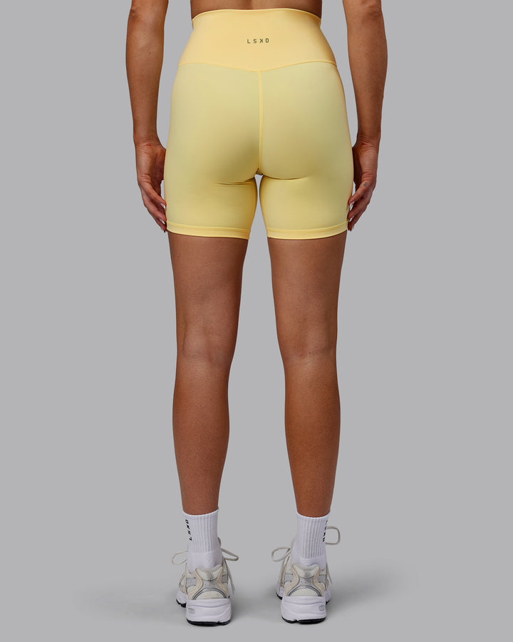 Woman wearing Sara Strike Cross Over Waist Mid Short Tights - Sunflower
