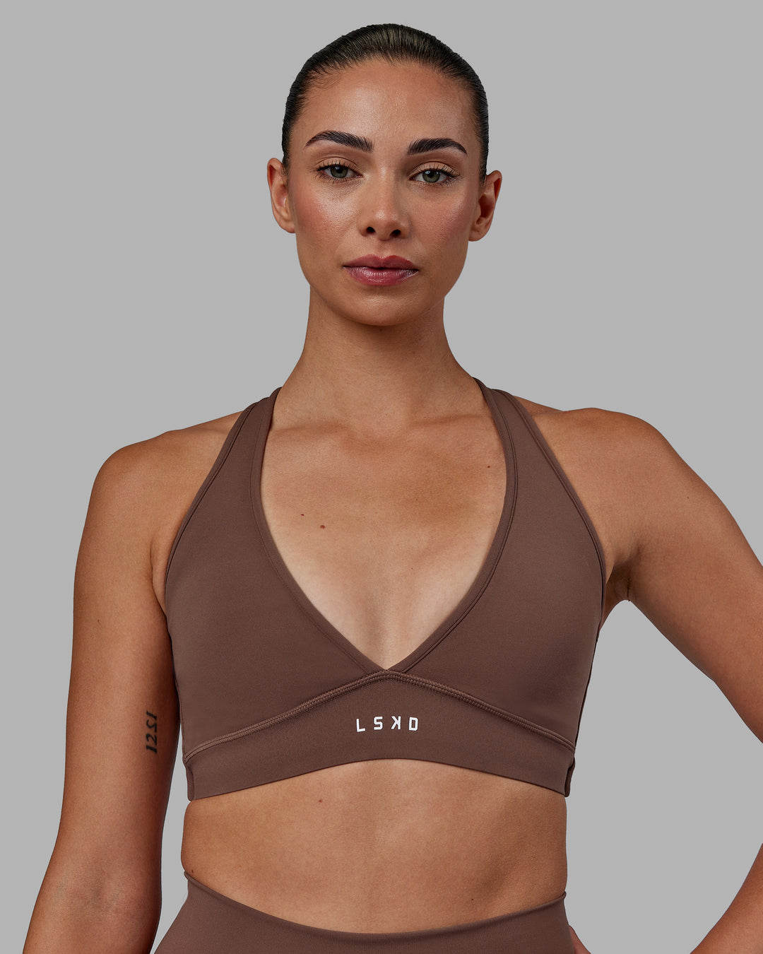 Woman wearing Stamina Sports Bra - Dull Rust